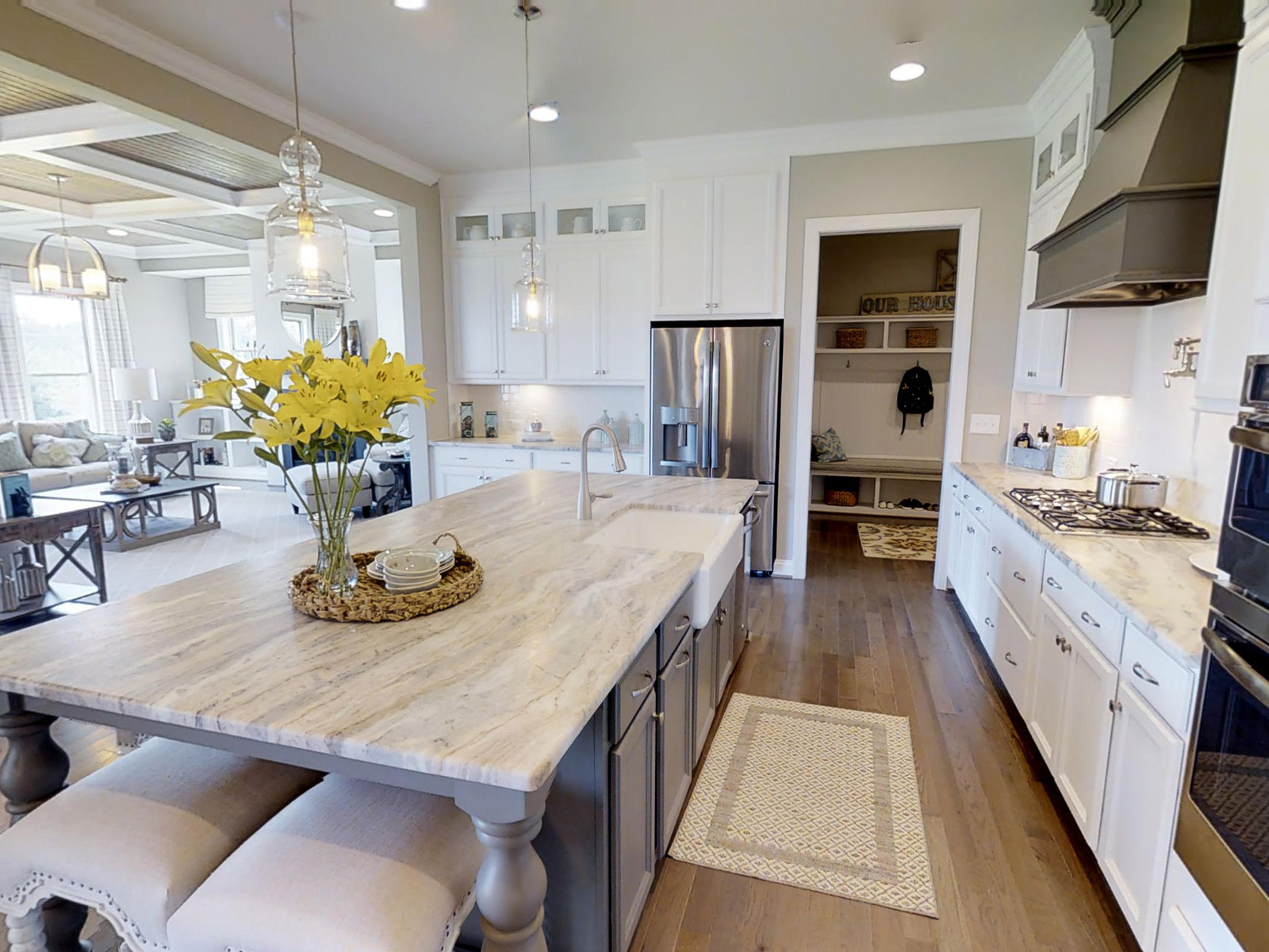 White and Gray Cabinets in the kitchen of the Crawford plan with leathered granite countertops.