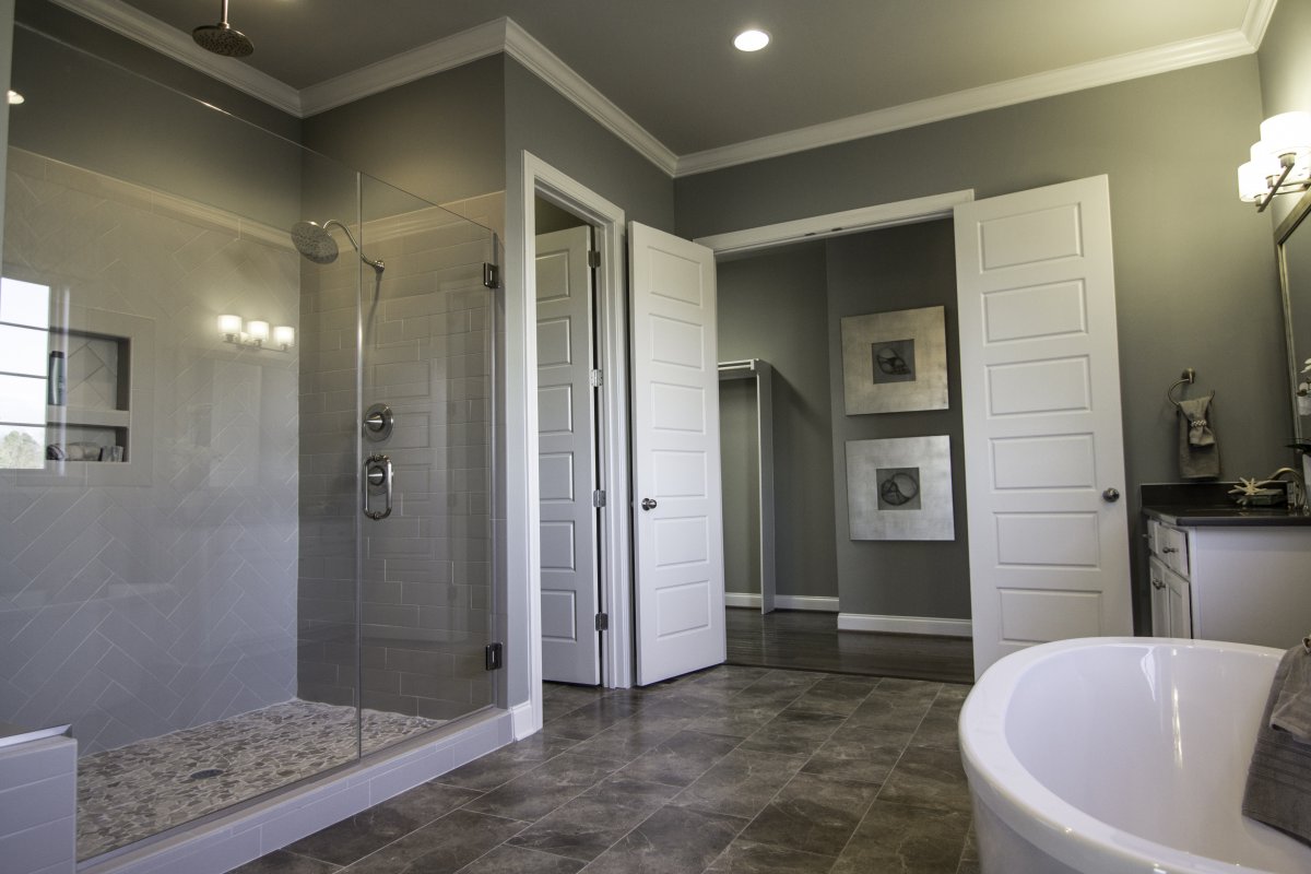 This Crawford's Owner's Bath features an oversized ceramic tile shower and a free standing tub and large walk-in closet.